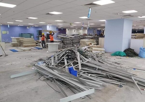 Dismantled metal partitions staged for scrap pickup